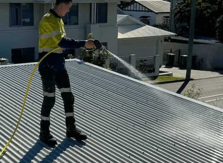 A man doing roof pressure washing